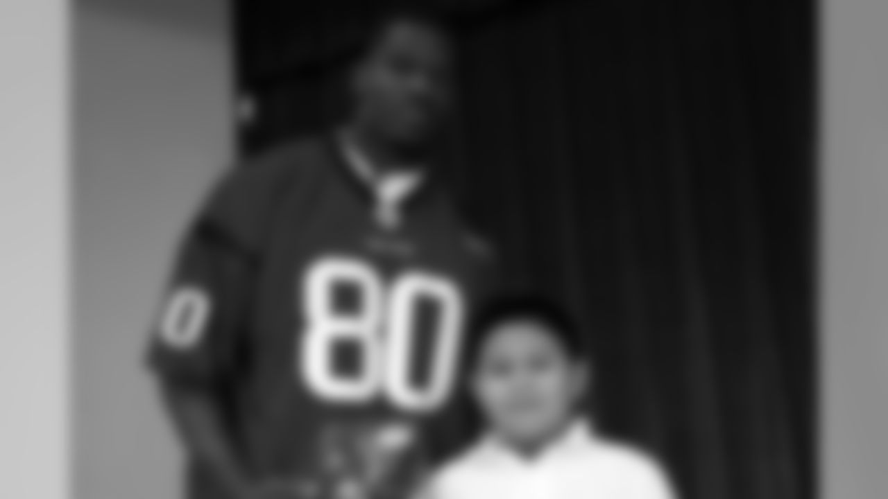 A happy student was the recipient of a Texans mini-helmet autographed by Johnson's teammate, cornerback Dunta Robinson.