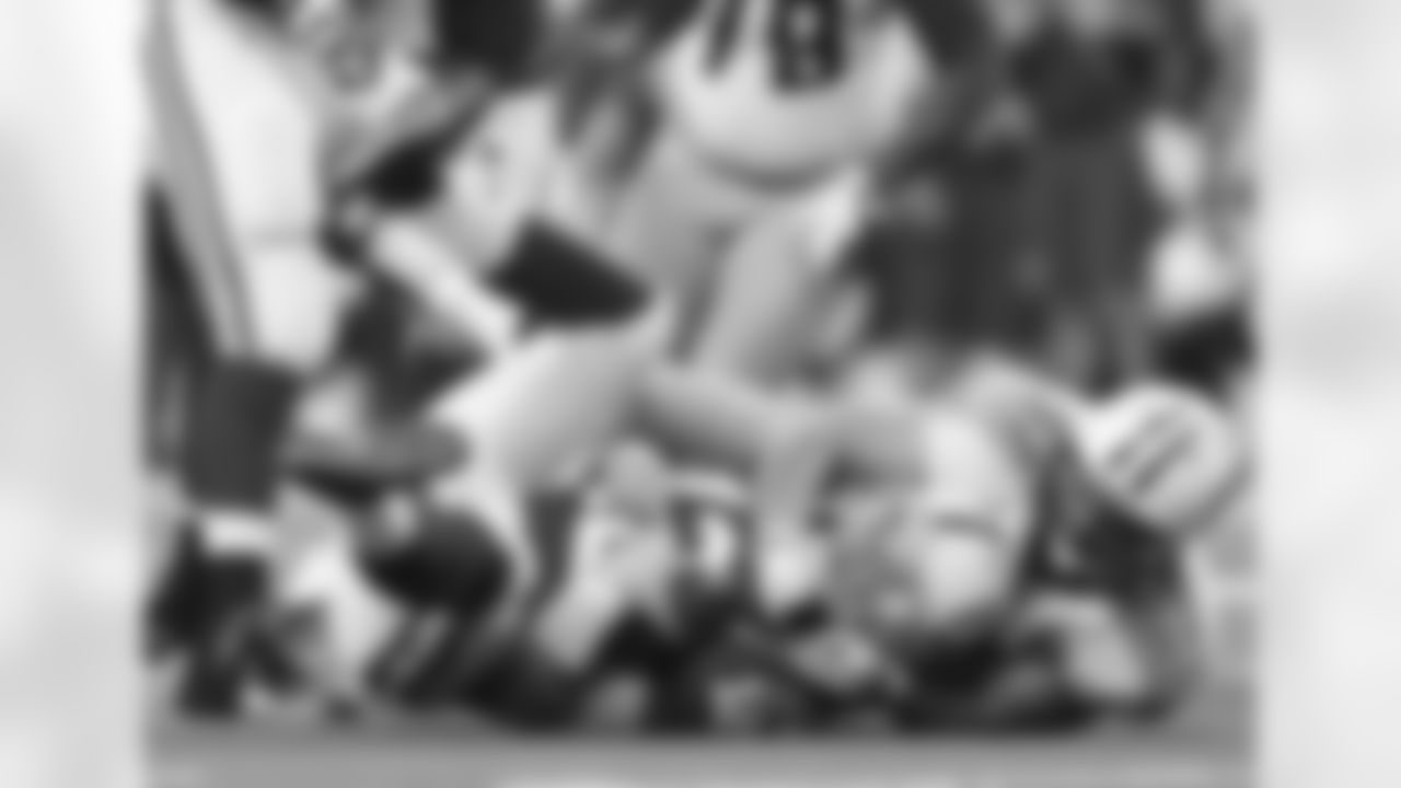 Indianapolis Colts' Andrew Luck (12) is sacked by Tennessee Titans' Karl Klug (97) during the first half of an NFL football game Sunday, Dec. 9, 2012, in Indianapolis. (AP Photo/Jeff Roberson)