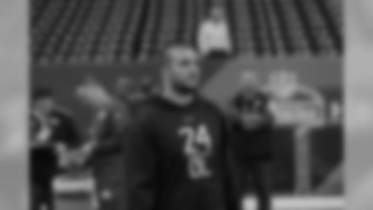 Oregon offensive lineman Hroniss Grasu watches players warm up at the NFL football scouting combine in Indianapolis, Friday, Feb. 20, 2015. (AP Photo/David J. Phillip)