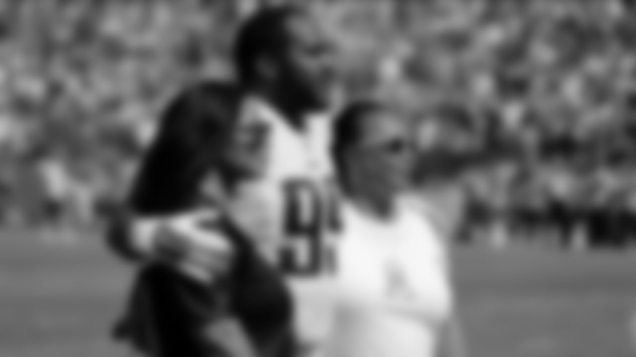 Tennessee Titans defensive end Jurrell Casey (99) hugs his fiancé Ryan Gray, left, and her mother, Mary Russell, a breast cancer survivor, in honor of breast cancer awareness, before an NFL football game against the Buffalo Bills, Sunday, Oct. 11, 2015, in Nashville, Tenn. (AP Photo/James Kenney)