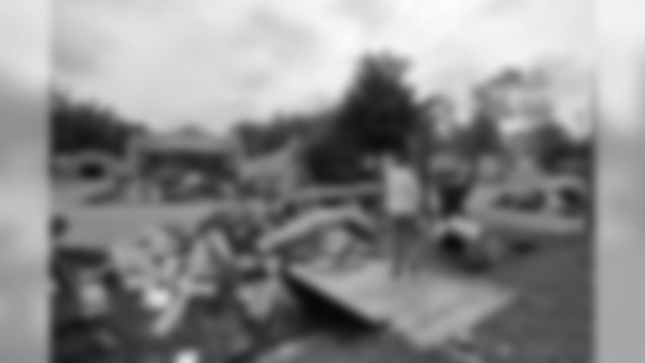 Tennessee Titans players, coaches and staff assist in cleanup efforts and removal of debris from wrecked homes caused from the historical flooding in a west Nashville neighborhood on Wednesday, May 11, 2010.