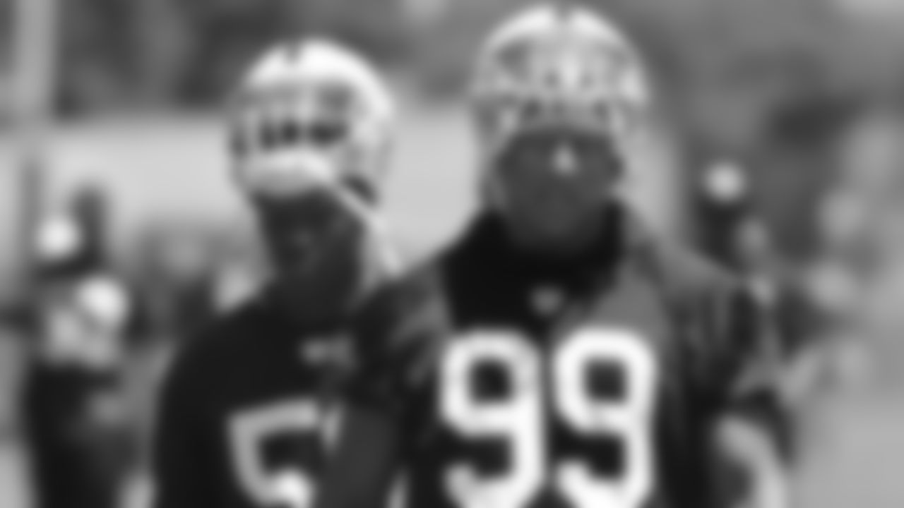Oakland Raiders defensive end Jack Crawford, right, walks off the field after practice at the Raiders mini camp in Alameda, Calif., Thursday, June 19, 2014. (AP Photo/Rich Pedroncelli)