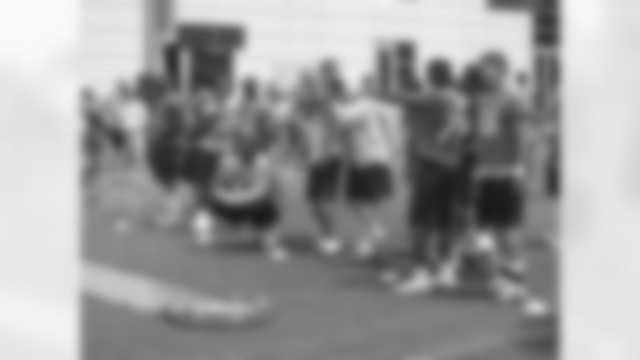 Titans players enjoy some light moments at the end of Friday's organized training activity (OTA) at Baptist Sports Park in Nashville, Tenn.