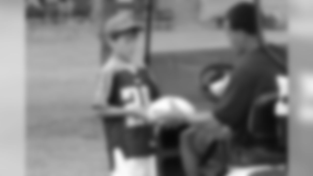 Cortland Finnegan signs a football for young fan Carson Walker