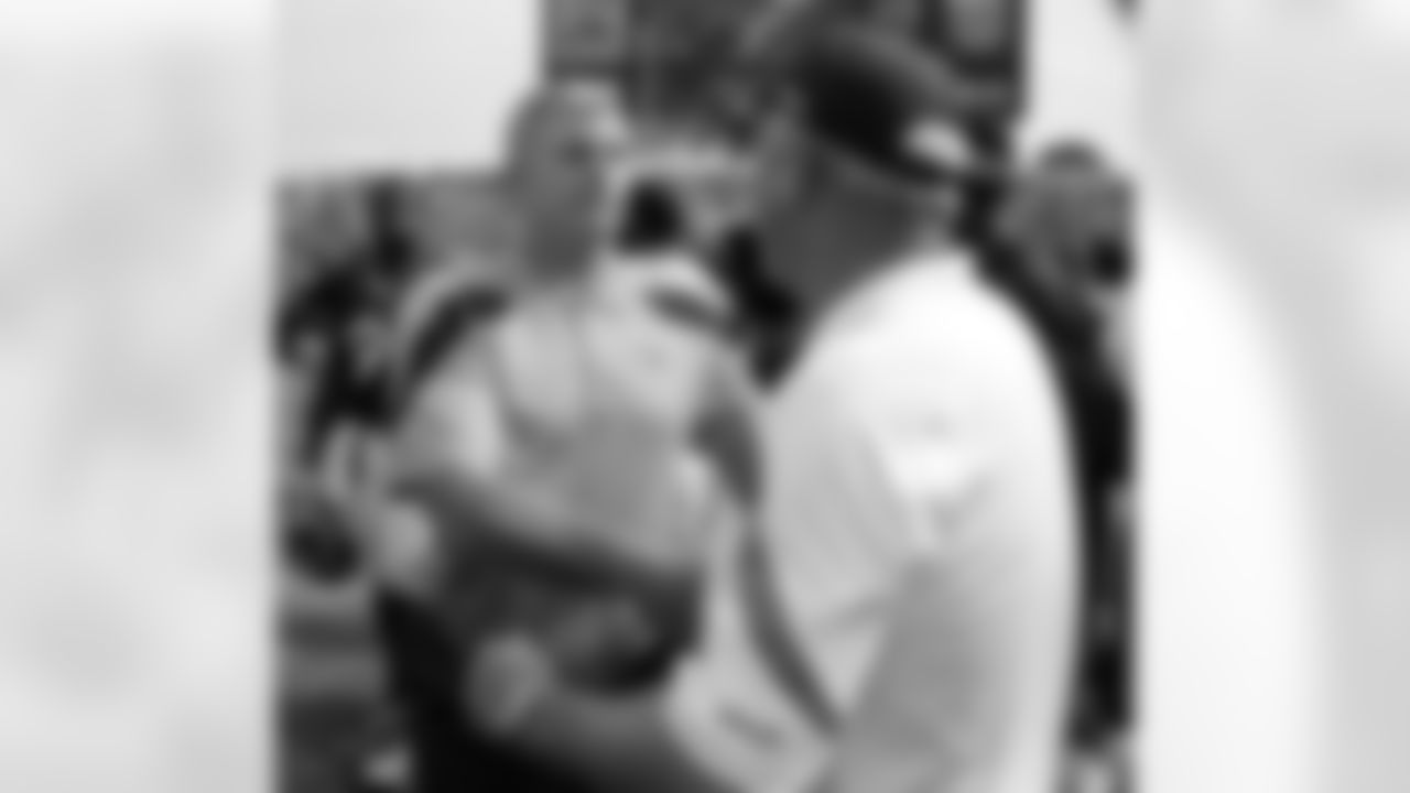 Tennessee Titans head coach Mike Munchak, left, shakes hands with Denver Broncos head coach John Fox after the Titans won 17-14 in an NFL football game on Sunday, Sept. 25, 2011, in Nashville, Tenn. (AP Photo/Frederick Breedon)