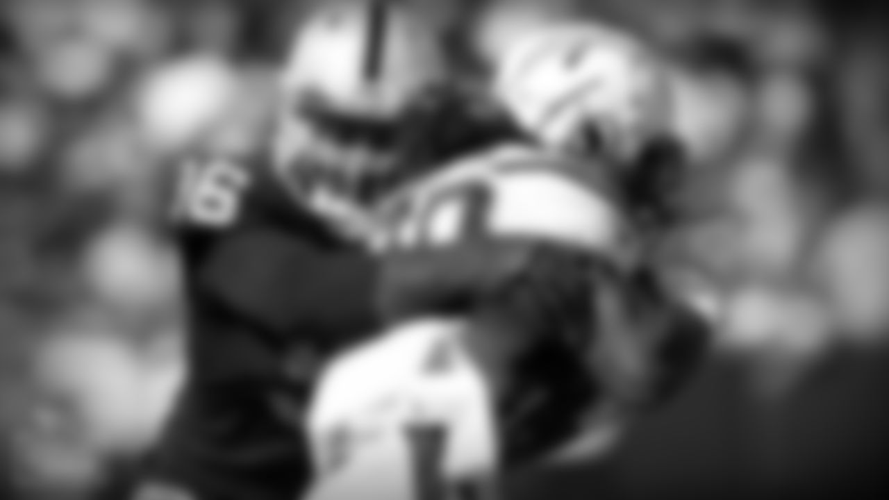 Oakland Raiders defensive end Denico Autry, left, tackles Los Angeles Chargers running back Melvin Gordon during the first half of an NFL football game in Oakland, Calif., Sunday, Oct. 15, 2017. (AP Photo/D. Ross Cameron)