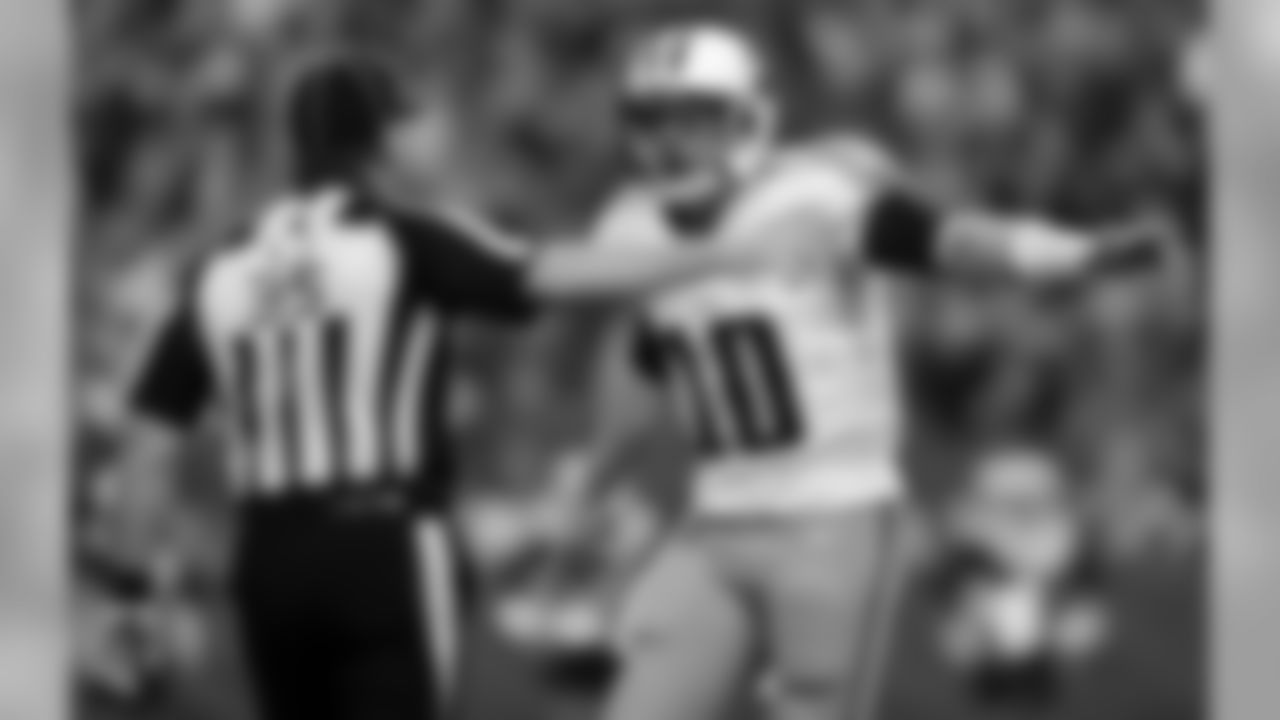 Tennessee Titans quarterback Jake Locker (10) discusses a call with line judge John Hussey (35) during the first half of an NFL football game against the Indianapolis Colts, Sunday, Dec. 9, 2012, in Indianapolis. (AP Photo/Jeff Roberson)
