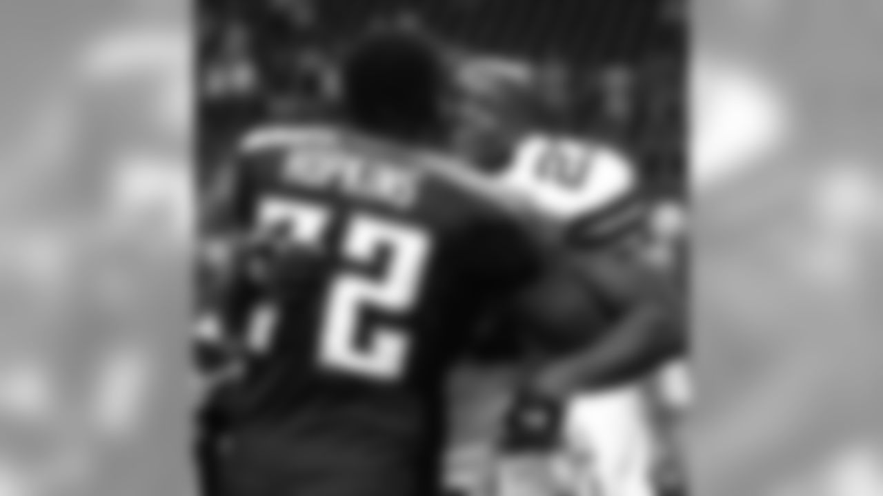 Dallas Cowboys running back Eddie George (27) hugs former teammate Tennessee Titans' Brad Hopkins (72) after their pre-season game in Irving, Texas, Monday, Aug. 30, 2004. The Cowboys won 20-17. (AP Photo/Tony Gutierrez)