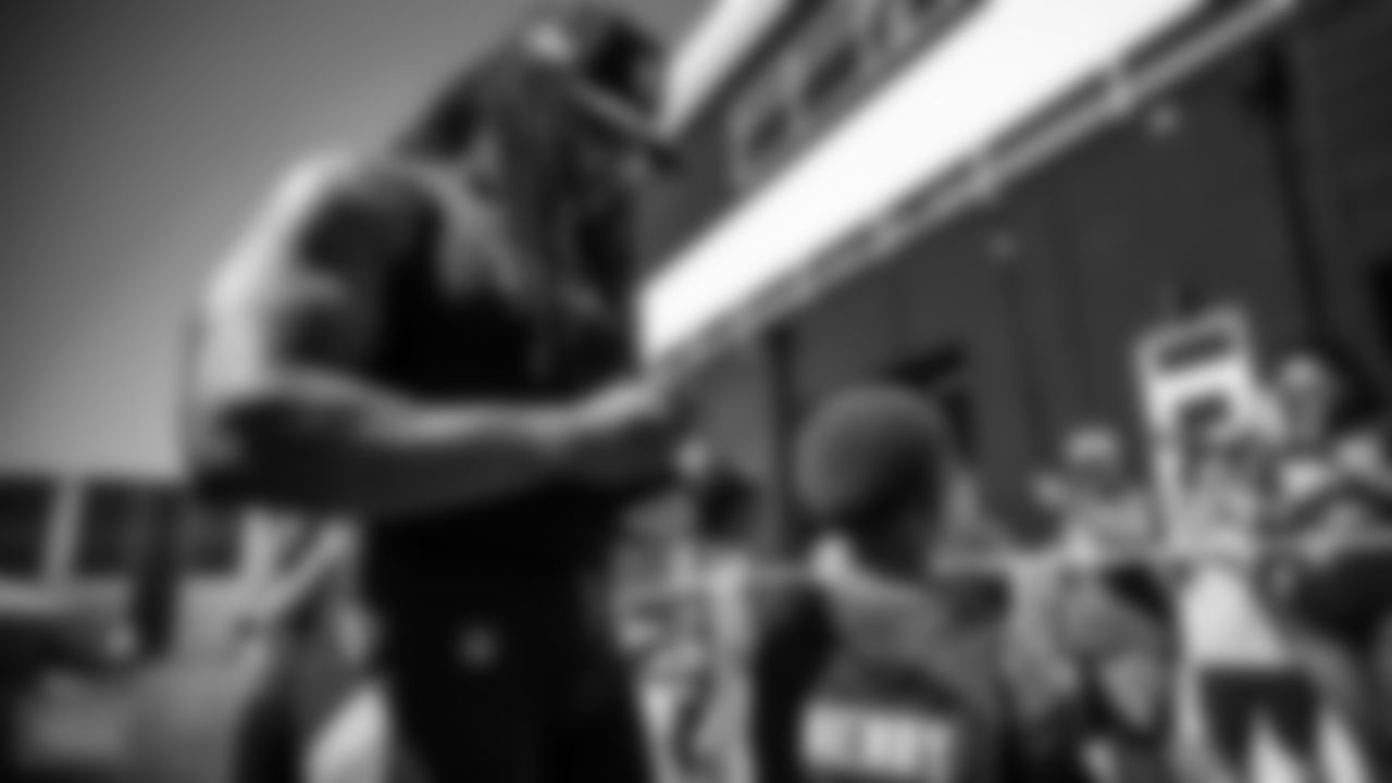 Running back Derrick Henry #22 of the Tennessee Titans signs autographs for fans during training camp practice at Ascension Saint Thomas Sports Park on August 13, 2022 in Nashville, TN. Photo By Donald Page/Tennessee Titans