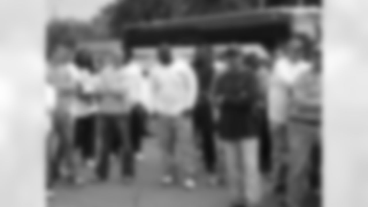 Tennessee Titans players, coaches and staff assist in cleanup efforts and removal of debris from wrecked homes caused from the historical flooding in a west Nashville neighborhood on Wednesday, May 11, 2010.
