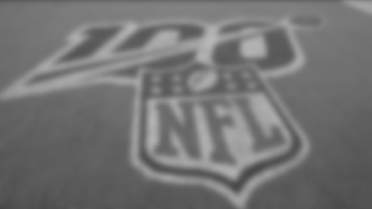 The 100th anniversary logon on the field before an NFL football game between the Jacksonville Jaguars and the Tennessee Titans Thursday, Sept. 19, 2019, in Jacksonville, Fla. (AP Photo/Phelan Ebenhack)