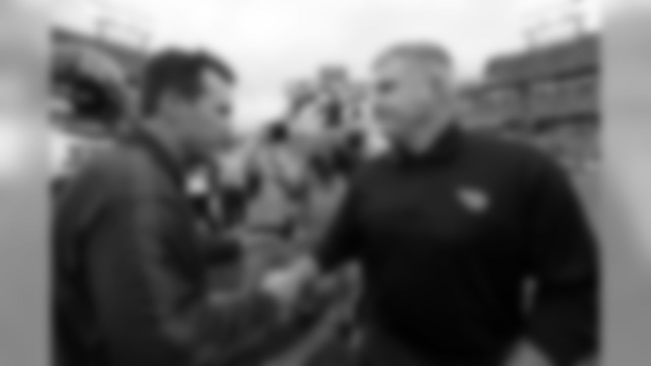 Tennessee Titans head coach Mike Munchak, right, congratulates Houston Texans head coach Gary Kubiak, left, after the Texans' 24-10 win in an NFL football game, Sunday, Dec. 2, 2012, in Nashville, Tenn. With the win, the Texans clinched their second straight playoff berth, a franchise-record 11th win this season, and their first season sweep of The Titans. (AP Photo/Joe Howell)