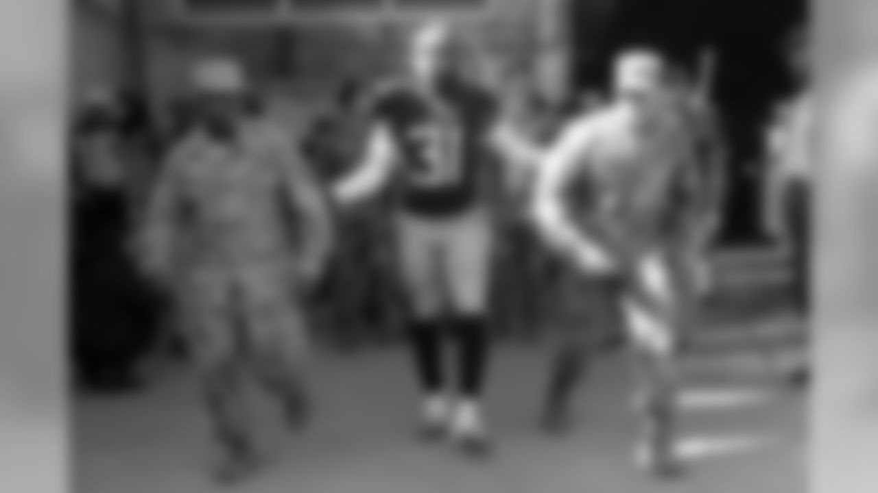 Tennessee Titans free safety Kevin Byard (31) takes the field with two soldiers before an NFL football game between the Titans and the New England Patriots Sunday, Nov. 11, 2018, in Nashville, Tenn. (AP Photo/James Kenney)