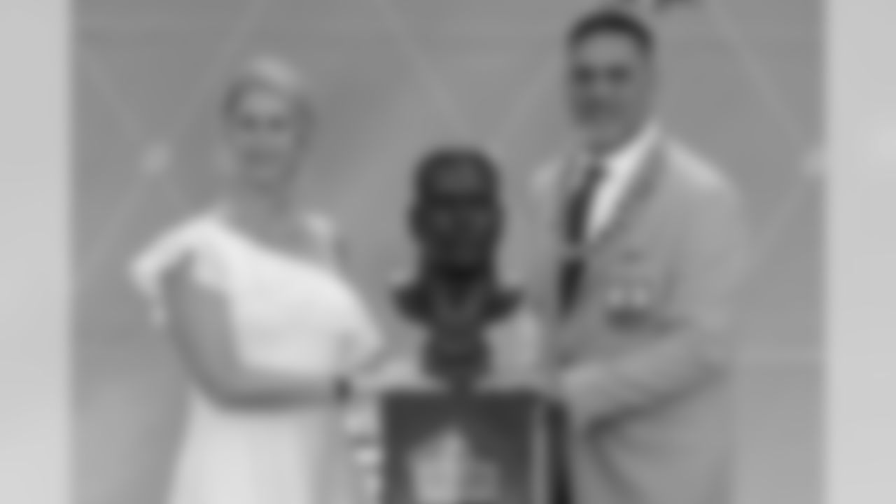 Former NFL player Kevin Mawae, right, poses with his presenter and wife, Tracy, during the induction ceremony at the Pro Football Hall of Fame, Saturday, Aug. 3, 2019, in Canton, Ohio. (AP Photo/Ron Schwane)