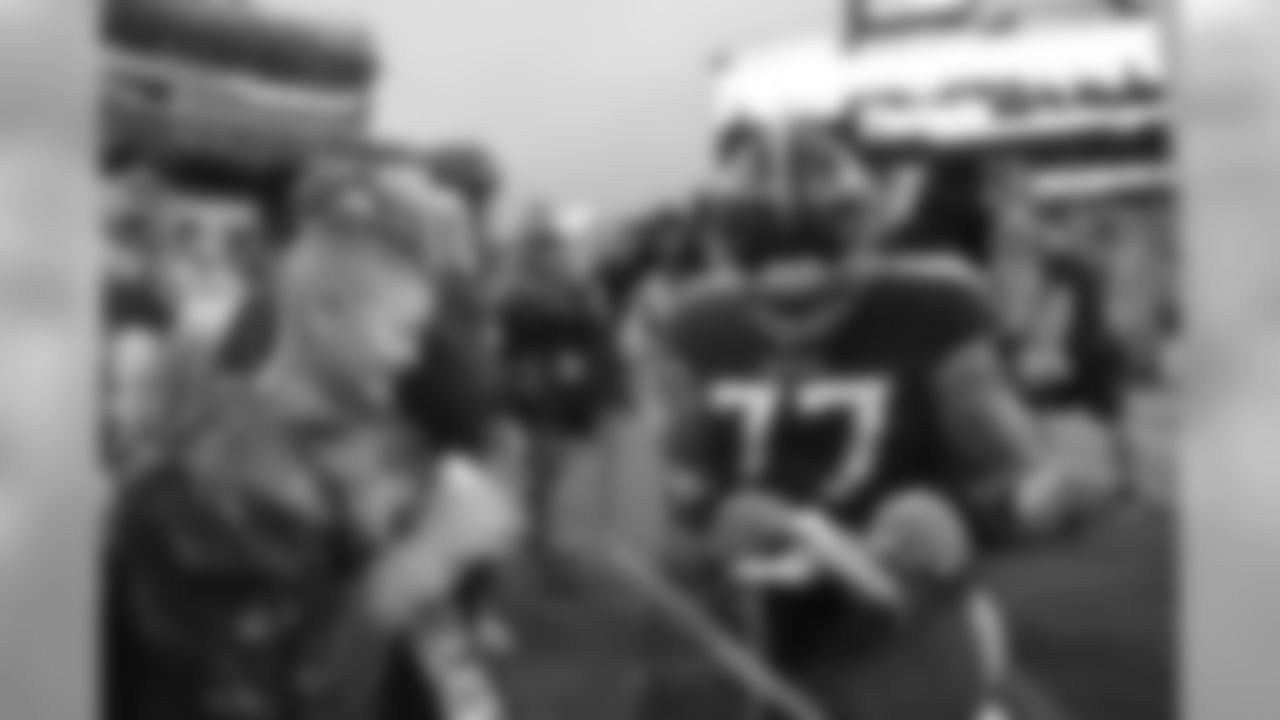 NASHVILLE, TN - AUGUST 25, 2019 - Tackle Taylor Lewan #77 of the Tennessee Titans signs glove for fan during the preseason home game between the Pittsburgh Steelers and the Tennessee Titans at Nissan Stadium in Nashville, TN. Photo By Kayla Schoen/Tennessee Titans