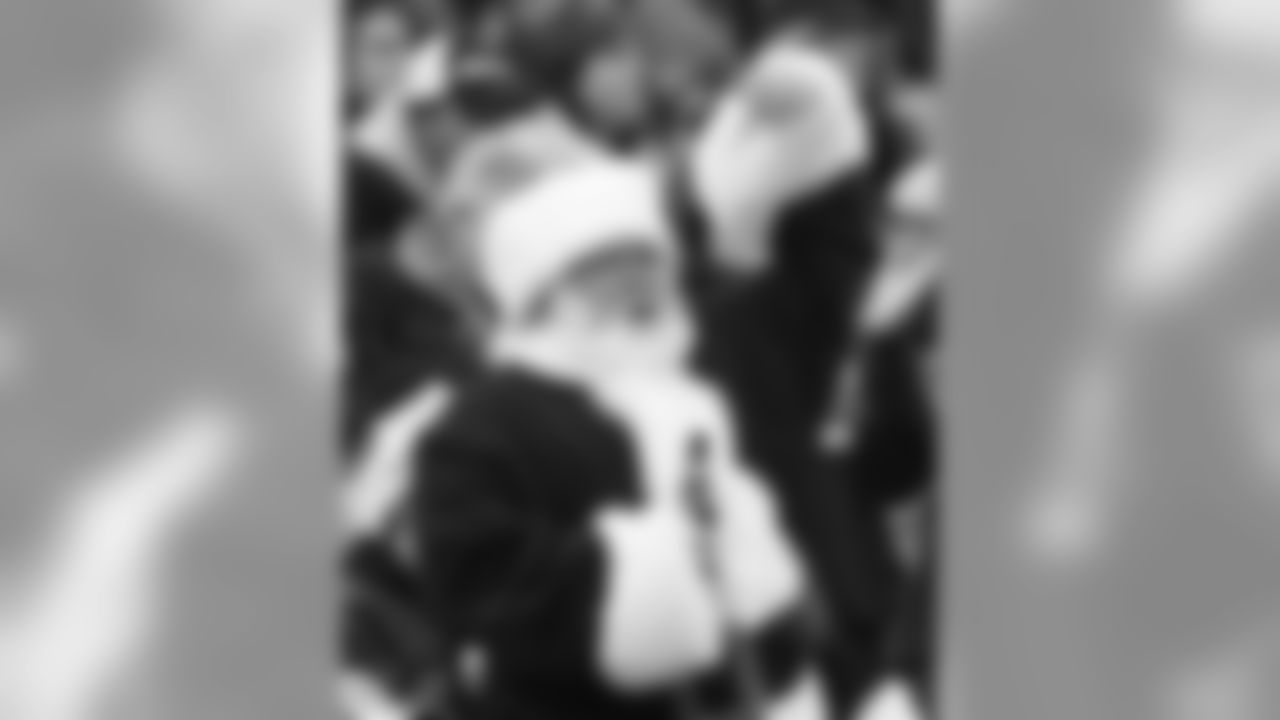 A Tennessee Titans fan dressed as Santa Claus holds his beer as he cheers in the first quarter of an NFL football game against the St. Louis Rams on Sunday, Dec. 13, 2009, in Nashville, Tenn. (AP Photo/Wade Payne)
