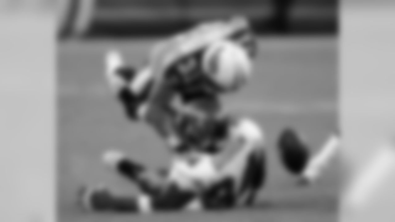 Tampa Bay Buccaneers running back Earnest Graham (34) loses the ball as he is hit by Tennessee Titans cornerback Cortland Finnegan (31) in the first quarter of an NFL preseason football game in Nashville, Tenn., Saturday, Aug. 15, 2009. (AP Photo/John Russell)