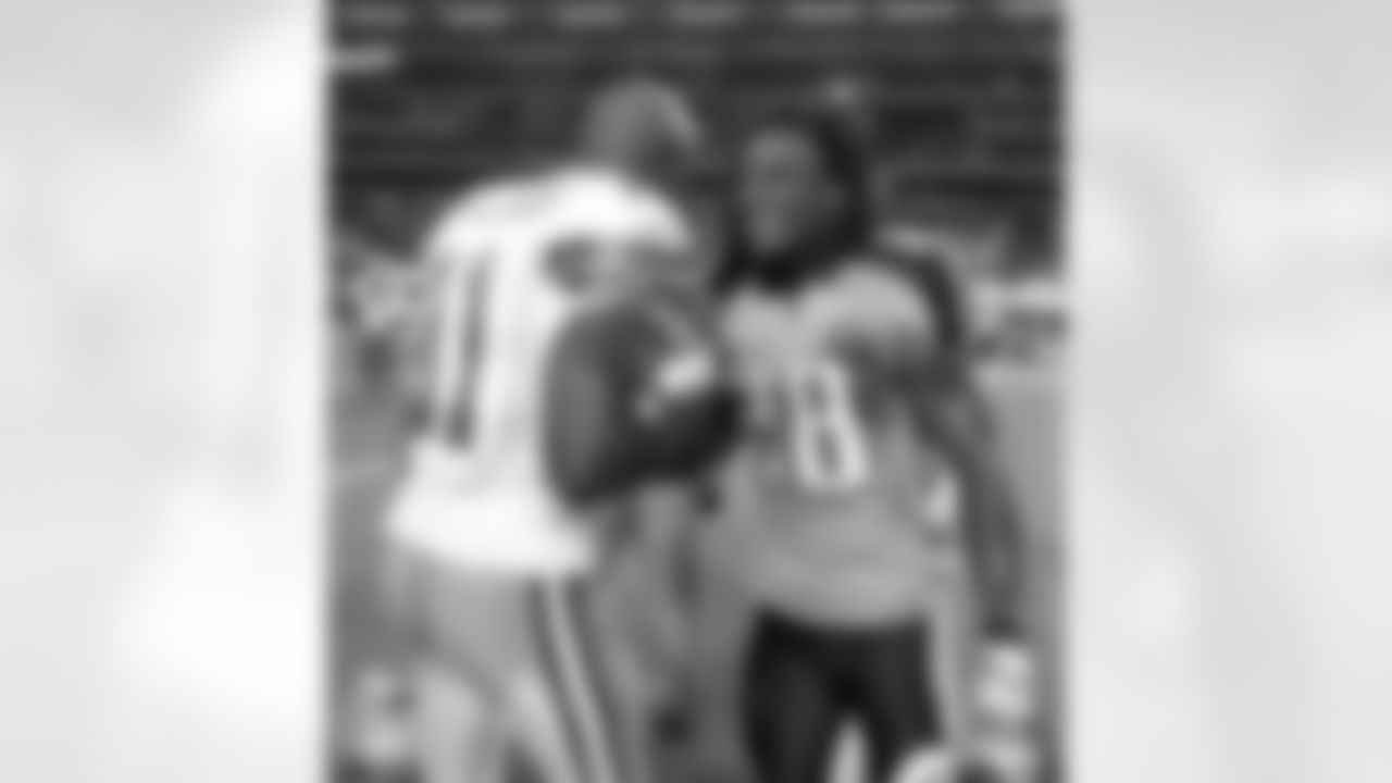 Tennessee Titans running back Chris Johnson (28) and Dallas Cowboys wide receiver Roy E. Williams (11) shake hands after an NFL football game Sunday, Oct. 10, 2010, in Arlington, Texas. Tennessee won 34-27. (AP Photo/Tim Sharp)