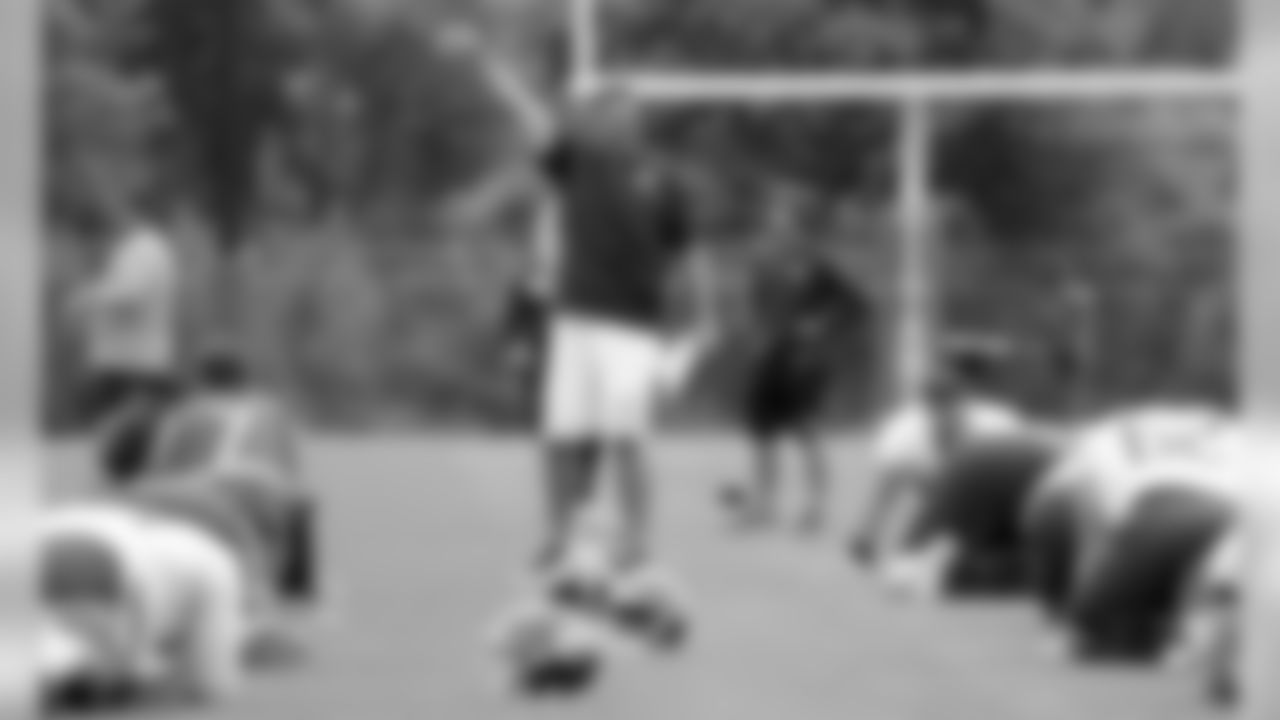 In this June 13, 2018 photo, Tennessee Titans head coach Mike Vrabel, center, watches as players warm up during NFL football minicamp in Nashville, Tenn. The Titans wrap up their first offseason under their new coach with the end of a three-day minicamp. Now they're off until the end of July and training camp. (AP Photo/Mark Humphrey)