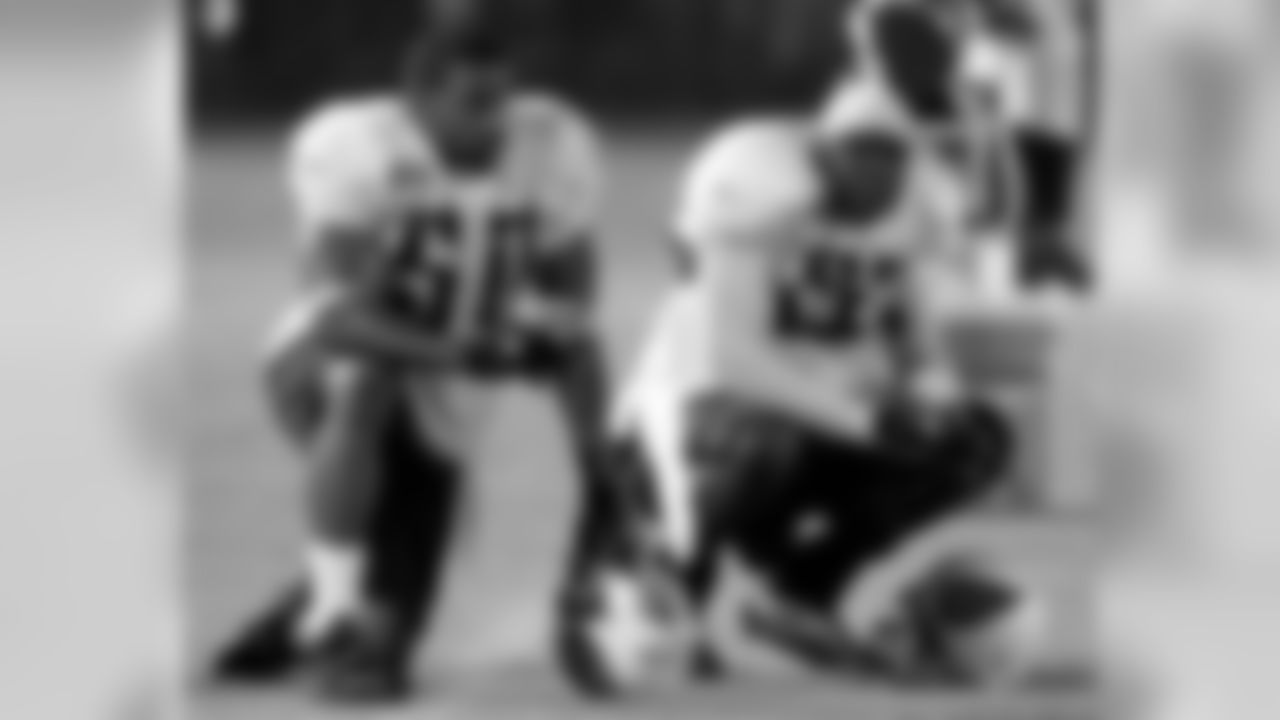 Tennessee Titans linebackers David Thornton (50) and Keith Bulluck, right, wait for their turn on the field during football training camp in Clarksville, Tenn. on Monday, July 31, 2006. Thornton is one of the free agent additions to the team. (AP Photo/Mark Humphrey)