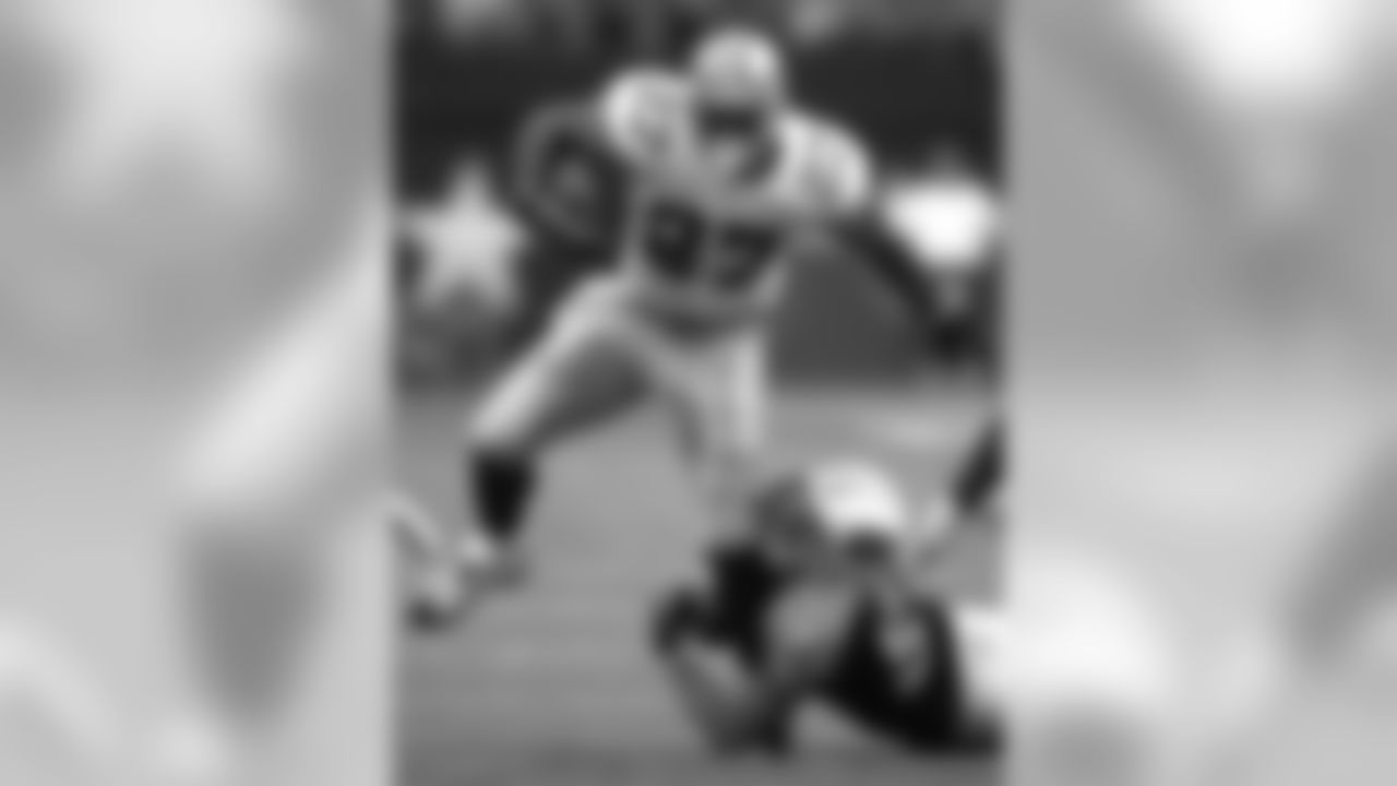 Dallas Cowboys running back Eddie George (27) is grabed by Tennessee Titans' Rocky Calmus (54) during the first quarter of pre-season play in Irving, Texas, Monday, Aug. 30, 2004. (AP Photo/LM Otero)