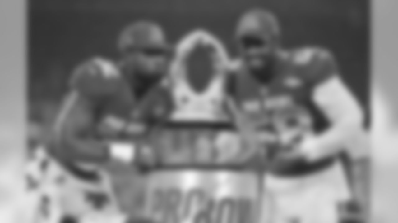 AFC linebacker Von Miller (58), of the Denver Broncos and tight end Delanie Walker (82), of the Tennessee Titans, pose with the NFL Pro Bowl trophy after defeating the AFC 24-23, in Orlando, Fla., Sunday, Jan. 28, 2018. (AP Photo/Steve Nesius)
