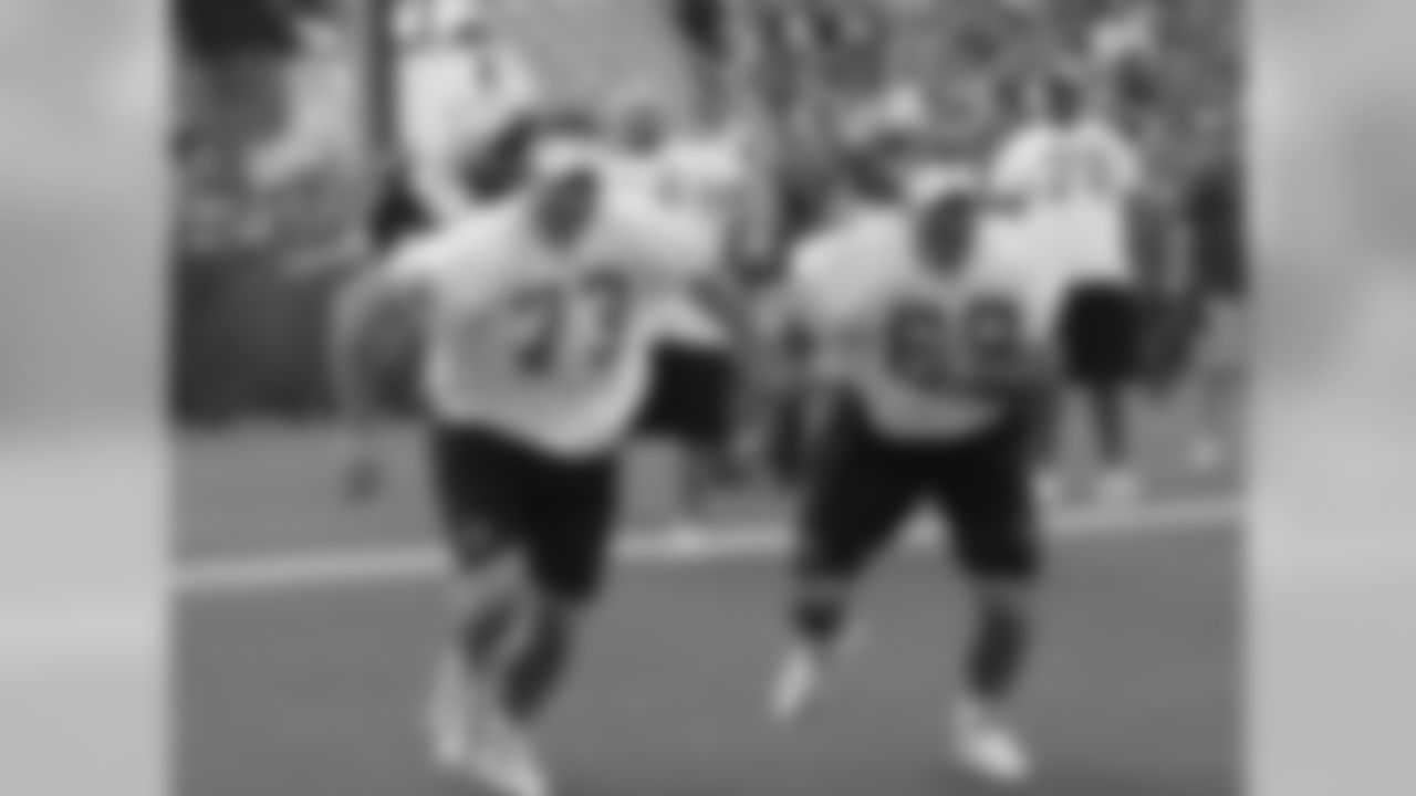 Cleveland Browns tackle Joe Thomas (73) runs with Tennessee Titans center Kevin Mawae (68) during a practice for the NFL football Pro Bowl Saturday, Jan. 30, 2010, in Fort Lauderdale, Fla. (AP Photo/David J. Phillip)