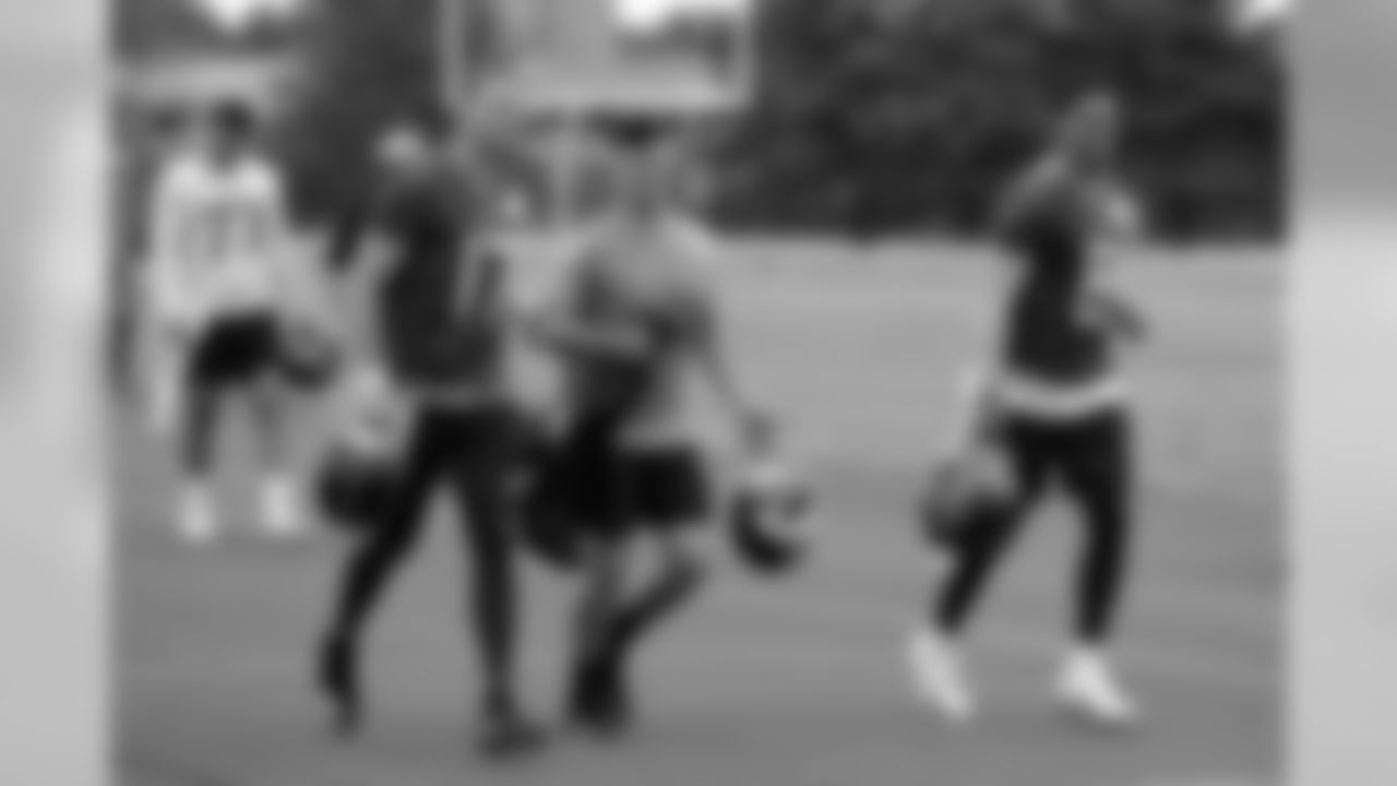 Tennessee Titans quarterbacks Ryan Tannehill (17), Logan Woodside, center, and Marcus Mariota (8) leave the field after an organized team activity at the Titans' NFL football training facility Wednesday, June 12, 2019, in Nashville, Tenn. (AP Photo/Mark Humphrey)