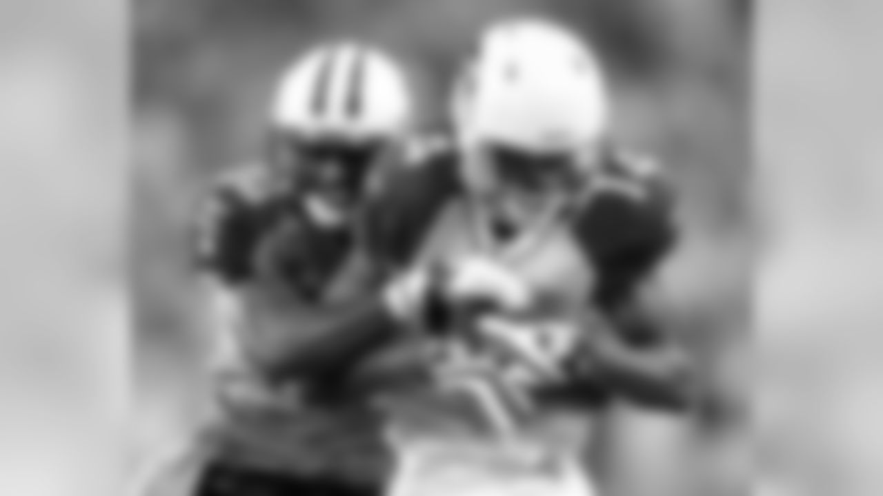 Arizona Cardinals wide receiver Stephen Williams (14) catches a pass as he is defended by Tennessee Titans cornerback Jason McCourty (30) in the second quarter of a preseason NFL football game on Monday, Aug. 23, 2010, in Nashville, Tenn. (AP Photo/Wade Payne)