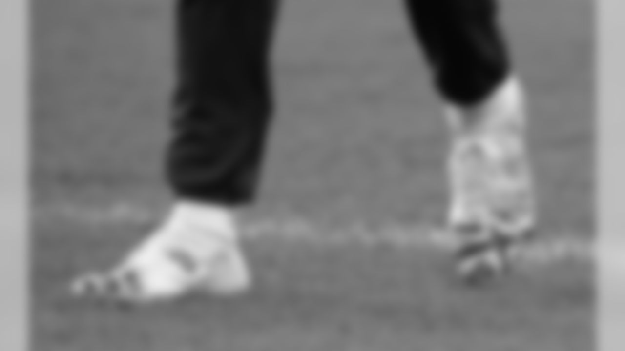 A close-up of the boots of Tennessee Titans quarterback Marcus Mariota as he warms-up before an NFL football game against Los Angeles Chargers at Wembley stadium in London, Sunday, Oct. 21, 2018. (AP Photo/Matt Dunham)