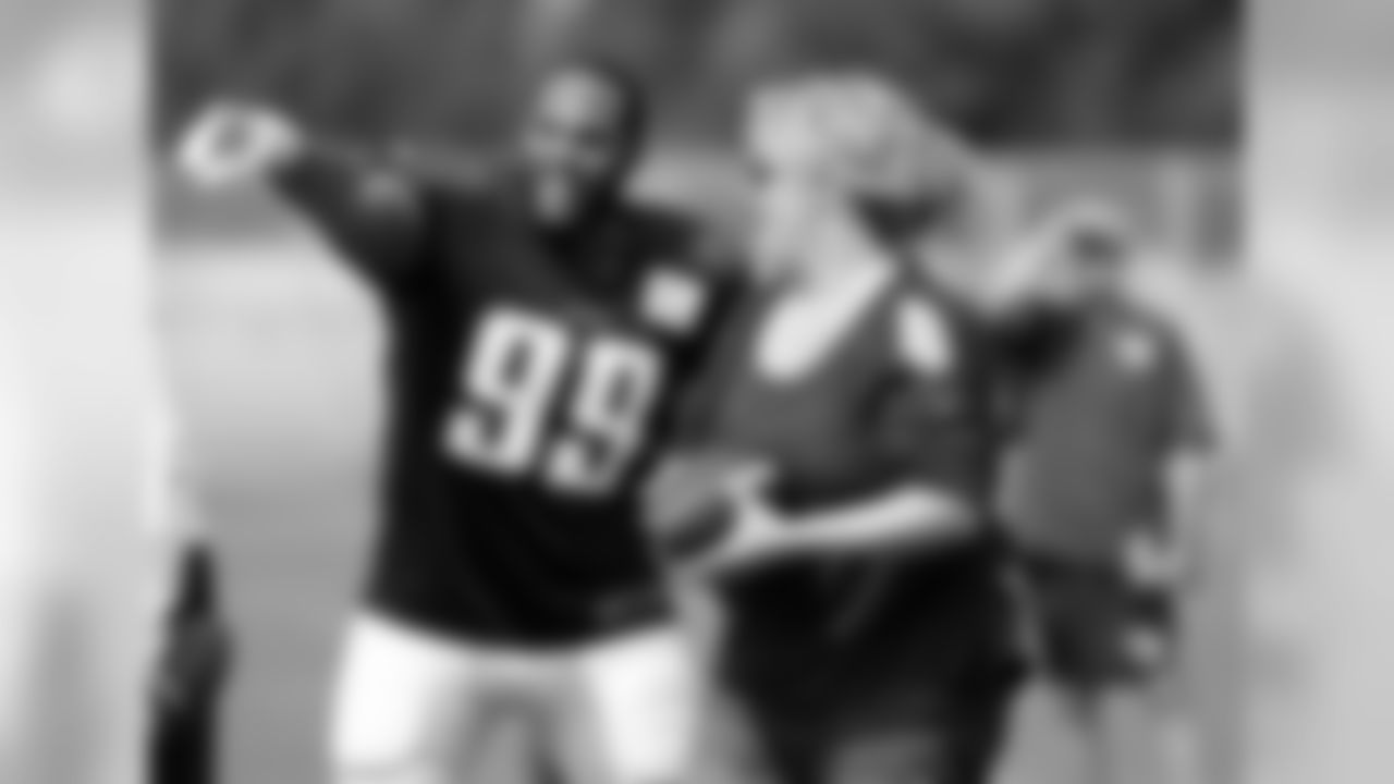 Tennessee Titans defensive end Jurrell Casey (99) helps fan Holly Cole as she tries to pass as many footballs as she can to several Titans players in one minute during a practice at NFL football training camp Thursday, Aug. 10, 2017, in Nashville, Tenn. The Titans have been holding the fan competition during each practice. (AP Photo/Mark Humphrey)