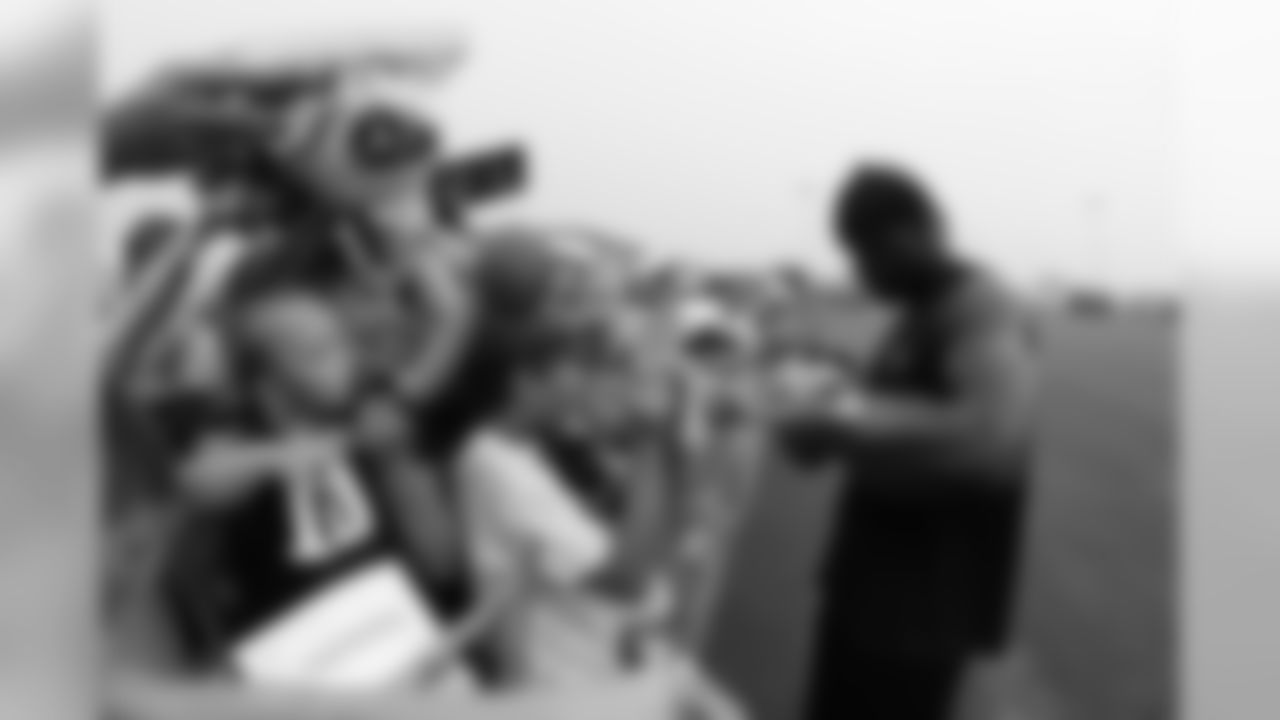 Tennessee Titans linebacker Keith Bulluck signs autographs during NFL football training camp in Nashville, Tenn., Saturday, Aug. 1, 2009. (AP Photo/Mark Humphrey)