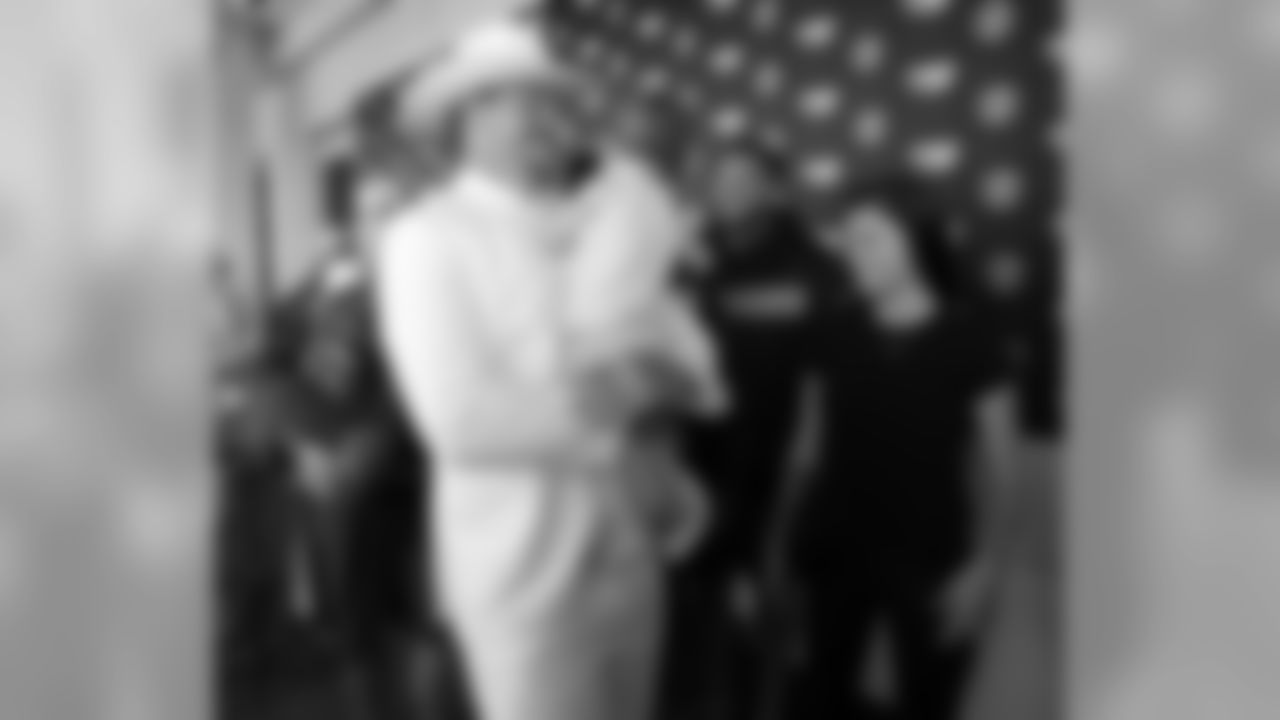 Tennessee Titans offensive tackle Taylor Lewan, dressed as Boss Hogg, a character from the television series "The Dukes of Hazard," carries his daughter, Wynne, 1, after a news conference at NFL football training camp Friday, July 27, 2018, in Nashville, Tenn. Lewan, a two-time Pro Bowl player, signed a contract extension reportedly worth $80 million with $50 million guaranteed on Friday, making him the NFL's highest-paid offensive lineman to date. At right is Lewan's wife, Taylin. (AP Photo/Mark Humphrey)