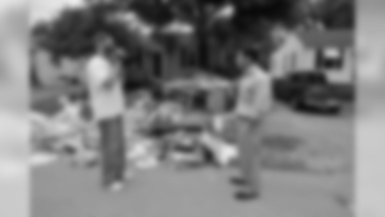 Tennessee Titans players, coaches and staff assist in cleanup efforts and removal of debris from wrecked homes caused from the historical flooding in a west Nashville neighborhood on Wednesday, May 11, 2010.