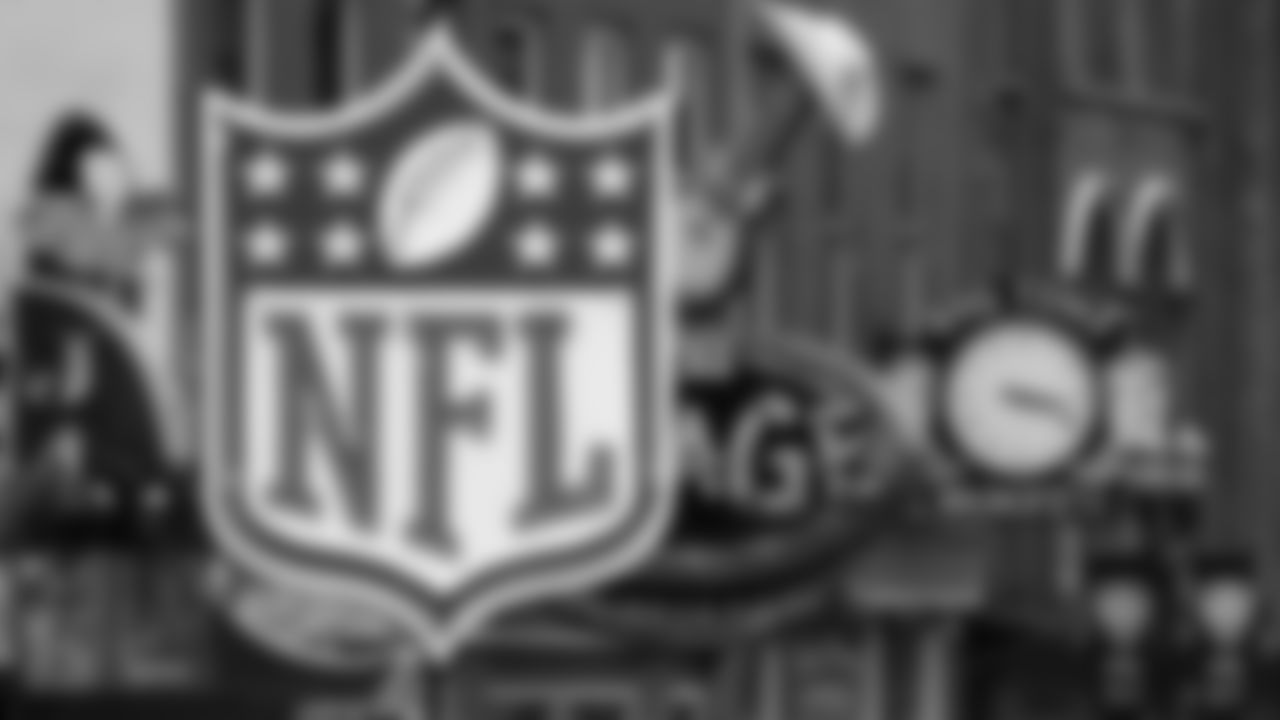 A temporary NFL neon sign joins the permanent ones along Broadway as preparation continues for the NFL Draft Tuesday, April 23, 2019, in Nashville, Tenn. The NFL Draft is scheduled to be held Thursday through Saturday. (AP Photo/Mark Humphrey)