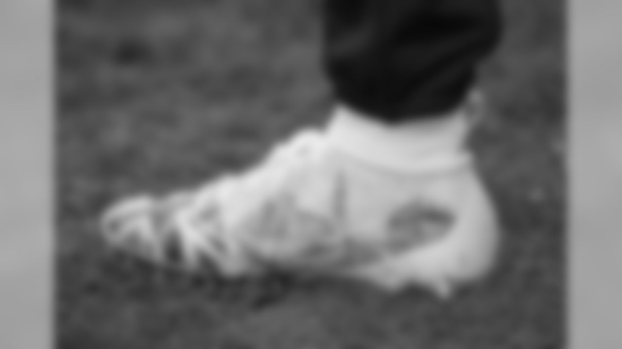 One of the boots of Tennessee Titans quarterback Marcus Mariota as he warms-up before an NFL football game against Los Angeles Chargers at Wembley stadium in London, Sunday, Oct. 21, 2018. (AP Photo/Matt Dunham)