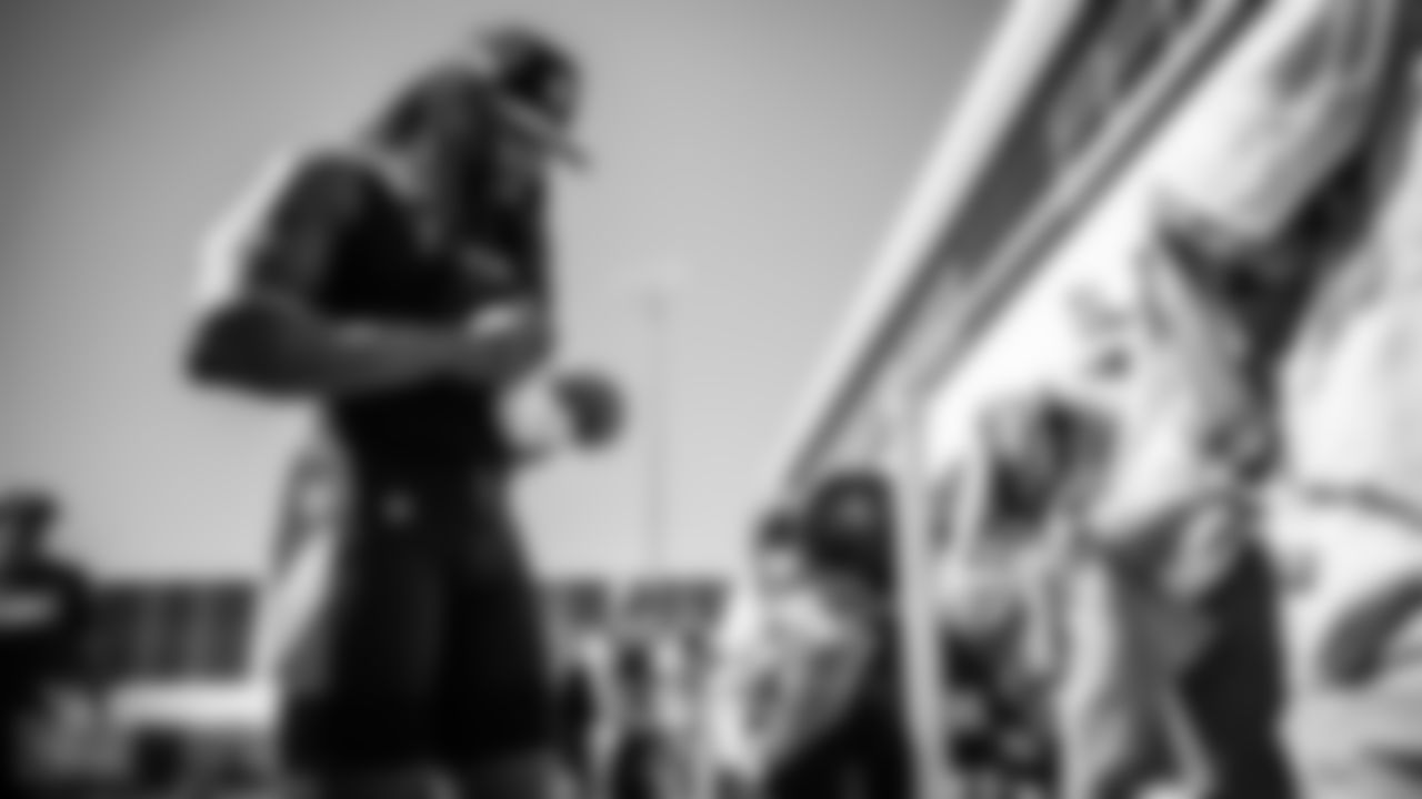 Running back Derrick Henry #22 of the Tennessee Titans signs autographs for fans during training camp practice at Ascension Saint Thomas Sports Park on August 13, 2022 in Nashville, TN. Photo By Donald Page/Tennessee Titans