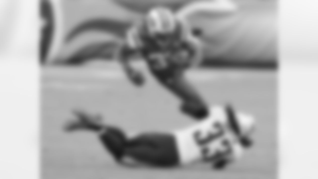 New York Jets running back Chris Ivory, top, is tripped up by Tennessee Titans safety Michael Griffin, bottom, in the first half of an NFL football game Sunday, Dec. 14, 2014, in Nashville, Tenn. (AP Photo/Mark Zaleski)