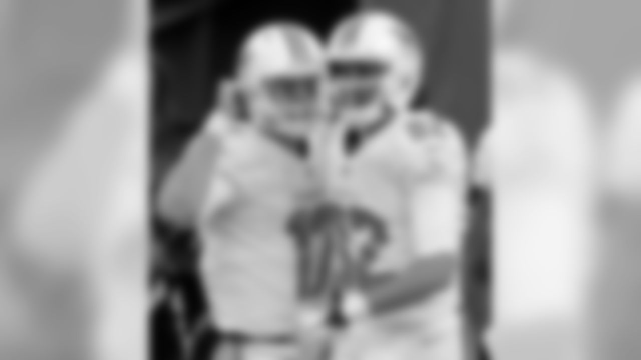 Miami Dolphins wide receiver Brian Hartline (82) and quarterback Ryan Tannehill (17) celebrate after the two combined for a touchdown pass against the New York Jets during the second half of an NFL football game Sunday, Dec. 1, 2013, in East Rutherford, N.J. (AP Photo/Seth Wenig)