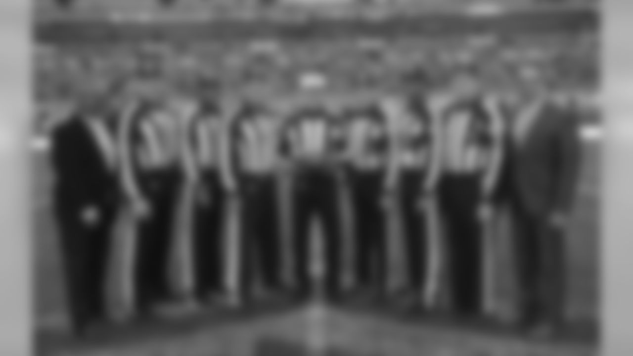 The officiating crew pose for a photo before the NFL football game between Tennessee Titans and Los Angeles Chargers at Wembley stadium in London, Sunday, Oct. 21, 2018. (AP Photo/Tim Ireland)