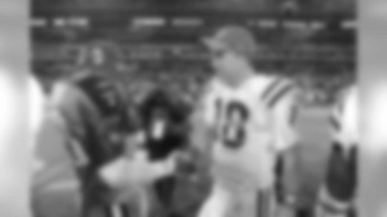 Indianapolis Colts quarterback Peyton Manning (18) shakes hands with Tennessee Titans linebacker Keith Bulluck (53) after an NFL football game in Nashville, Tenn., Sunday, Oct. 11, 2009. The Colts won 31-9. (AP Photo/John Russell)