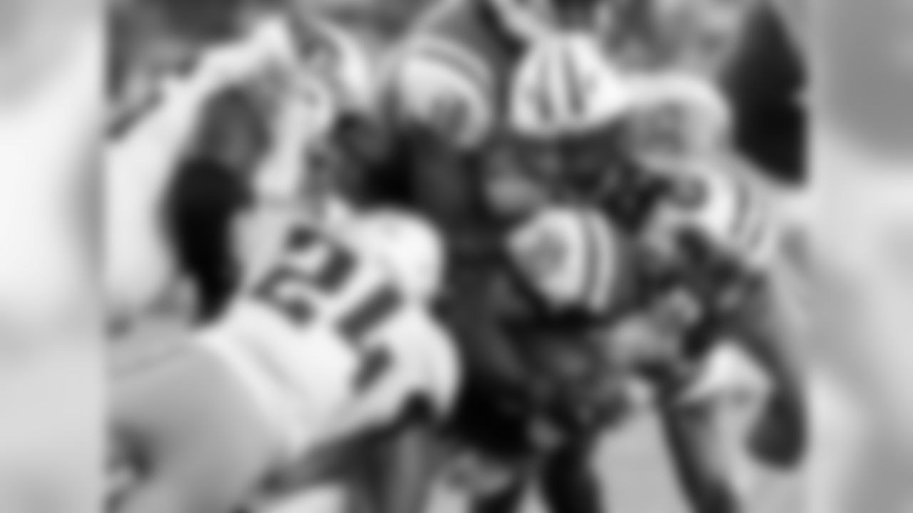 New York Jets running back Romar Morris (30) is tackled by the Tennessee Titans during the second quarter of an NFL football game, Saturday, Aug. 12, 2017, in East Rutherford, N.J. (AP Photo/Julio Cortez)