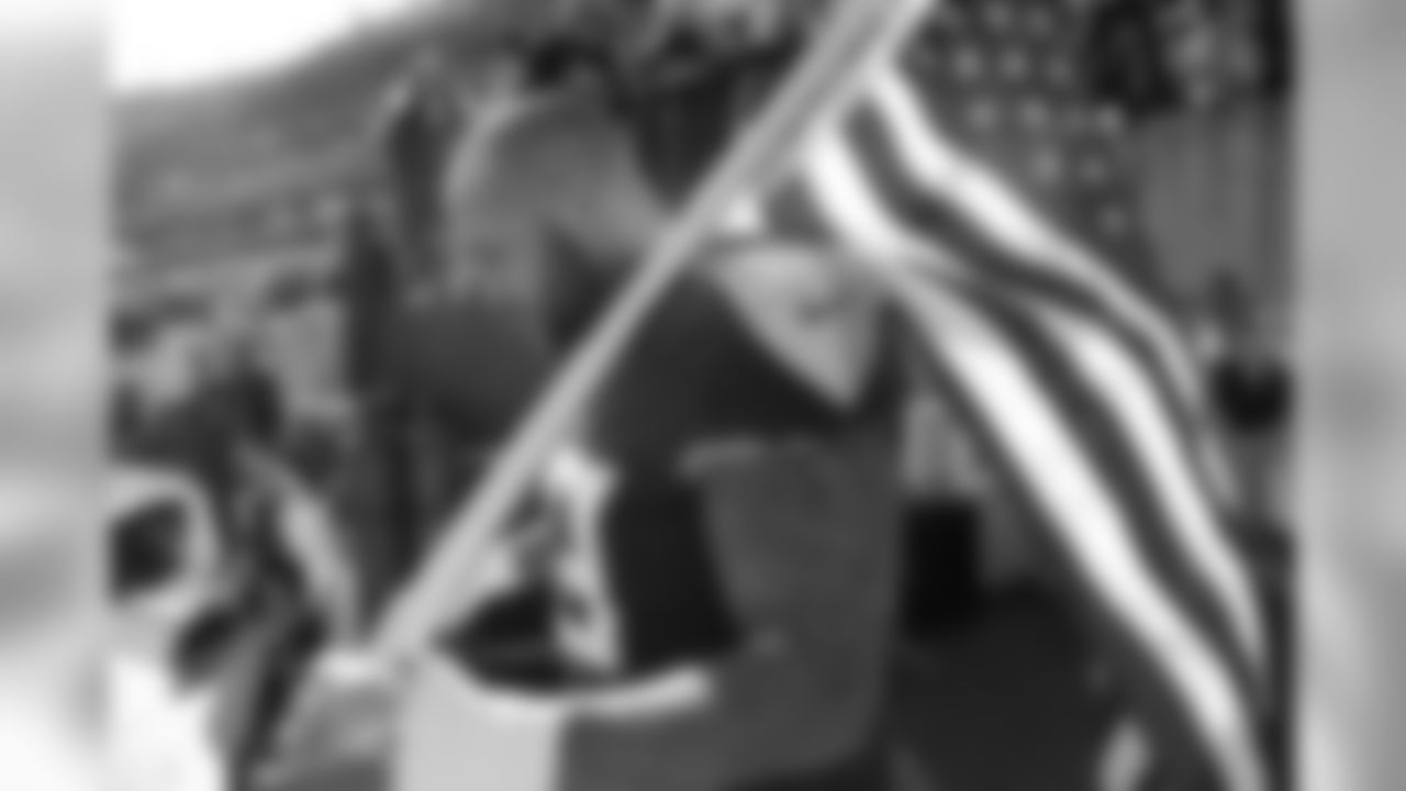 Tennessee Titans defensive end Jurrell Casey waits to carry an American flag onto the field before an NFL football game between the Titans and the New England Patriots Sunday, Nov. 11, 2018, in Nashville, Tenn. (AP Photo/James Kenney)