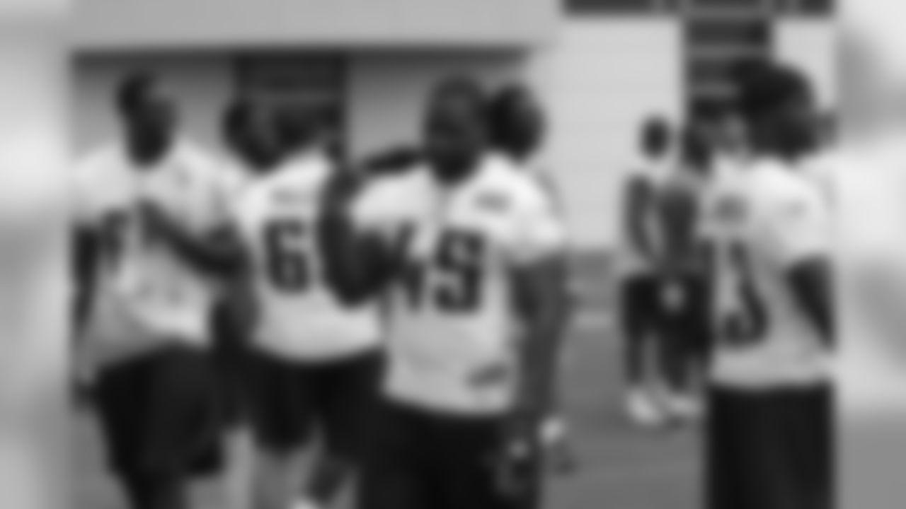 Titans players enjoy some light moments at the end of Friday's organized training activity (OTA) at Baptist Sports Park in Nashville, Tenn.