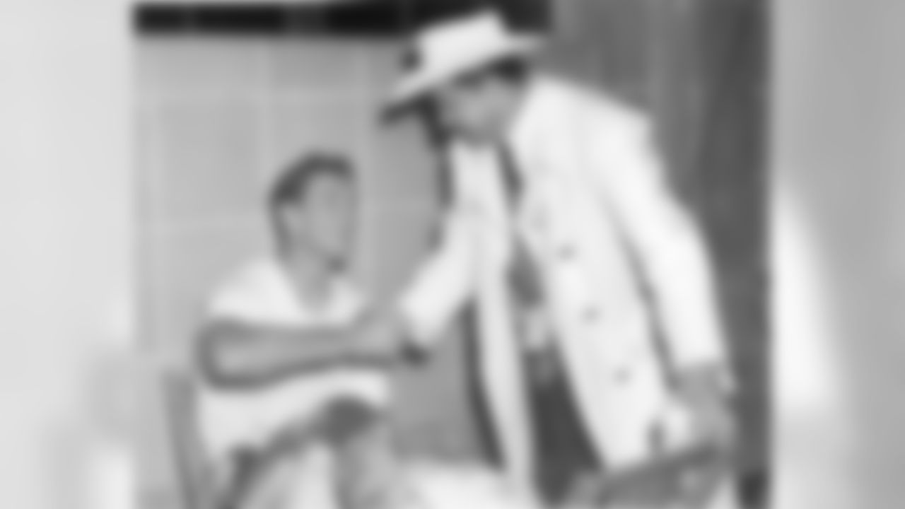 Bud Adams congratulates halfback Billy Cannon after the Oilers won the first AFL title.