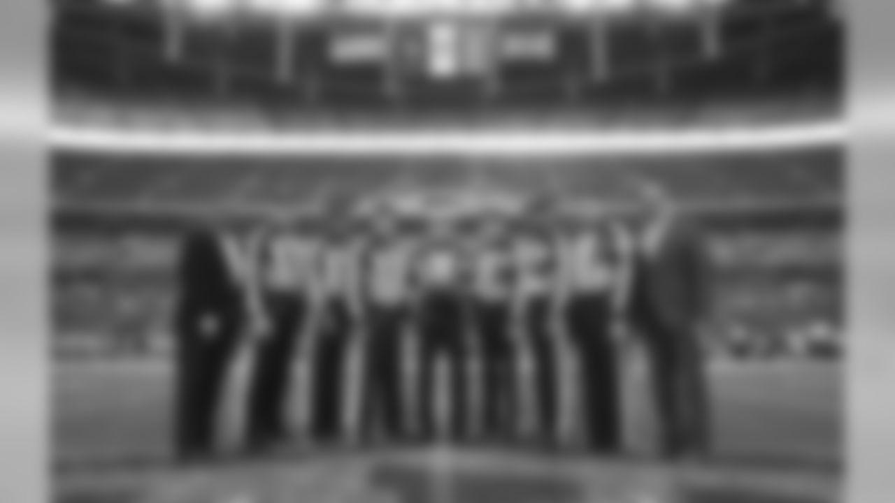 The officiating crew pose for a photo before the NFL football game between Tennessee Titans and Los Angeles Chargers at Wembley stadium in London, Sunday, Oct. 21, 2018. (AP Photo/Tim Ireland)