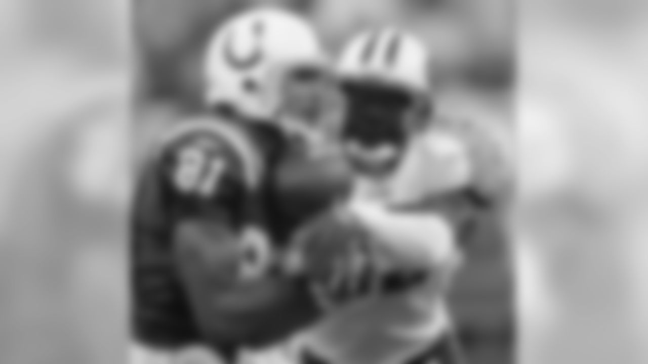 Indianapolis Colts tight end Bryan Fletcher, left, can't hold on to a pass under pressure from Tennessee Titans linebacker Keith Bulluck in the first quarter of an NFL football game in Indianapolis on Sunday, Oct. 8, 2006. (AP Photo/AJ Mast)