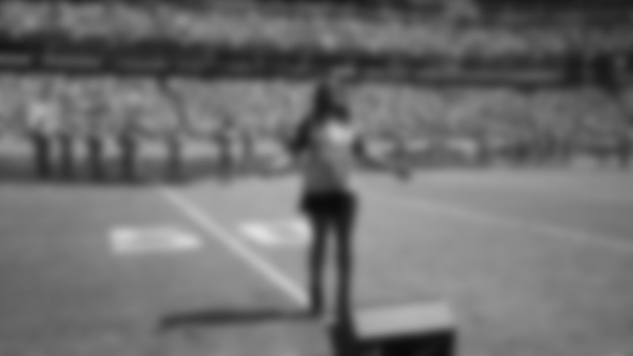 Taj George, wife of former Tennessee Titans running back Eddie George, sings the national anthem before an NFL football game between the Titans and the Indianapolis Colts Sunday, Sept. 15, 2019, in Nashville, Tenn. Eddie George's number is to be retired at halftime. Taj George is a member of the R&B singing group Sisters with Voices. (AP Photo/James Kenney)