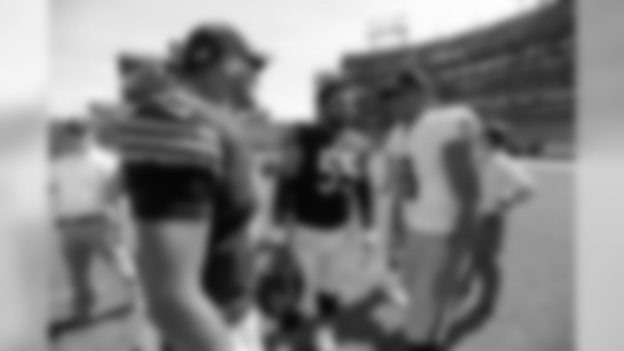 Chicago Bears quarterback Mitchell Trubisky, left, and center Hroniss Grasu (55) talk with Tennessee Titans quarterback Marcus Mariota (8) after an NFL football preseason game Sunday, Aug. 27, 2017, in Nashville, Tenn. The Bears won 19-7. (AP Photo/Mark Zaleski)