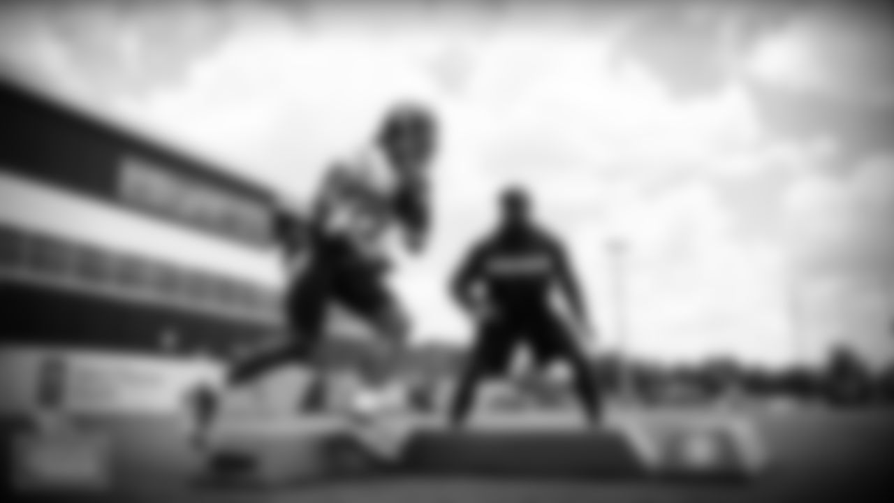 Running back Derrick Henry #22 of the Tennessee Titans and Running Backs Coach Tony Dews of the Tennessee Titans during minicamp at Saint Thomas Sports Park on JUNE 16, 2021 in Nashville, TN. Photo By Donald Page/Tennessee Titans